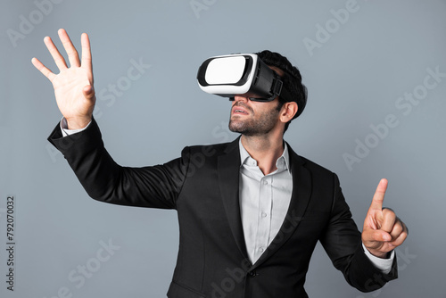 Skilled business man looking at data analysis while wearing VR glasses and suit. Project manager checking and choosing while using visual reality goggles or headset. Innovation technology. Deviation.