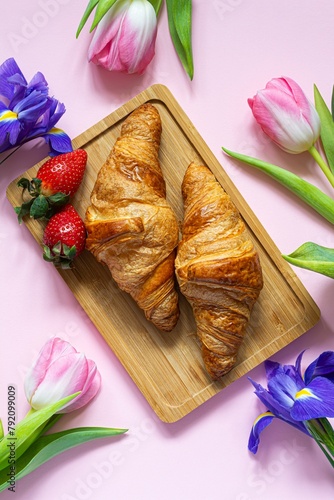 Happy mother's day, beautiful breakfast, lunch with  fresh croissants, strawberries on tray, bouquet of tulips as gift.