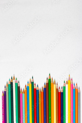 Frame made by waves of colored pencils. Back to school. School supplies.