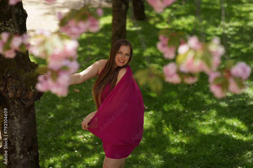 Portrait of European Woman in Burgundy Dress with Cherry Blossoms Portrait of European Woman in Burgundy Dress with Cherry Blossoms