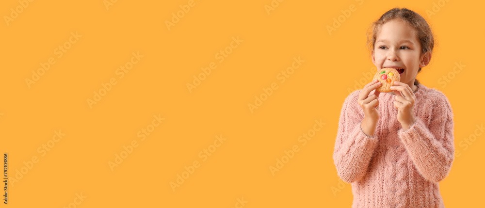 Cute little girl eating tasty cookie on yellow background Cute little girl eating tasty cookie on yellow background