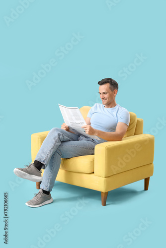 Handsome man reading newspa...