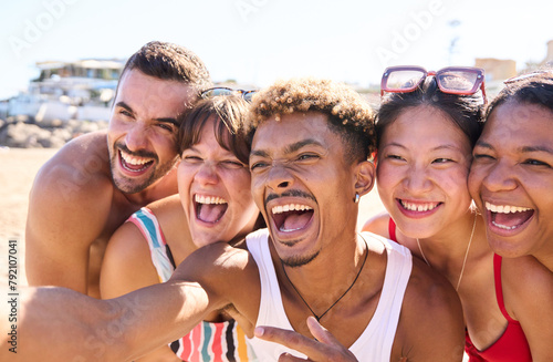 Group of excited diverse genders and races people taking selfie on beach together share big smiles and having fun. Portrait of young generation z people enjoying summer free time and vacations #792107041