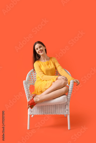 Young woman sitting in wick...