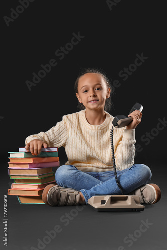 Cute little girl with telep...