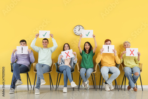 Applicants holding paper sh...