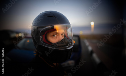 woman in helmet motorcyclist at sunset close-up