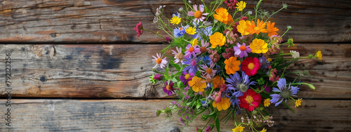 Colorful bouquet of wild flowers on wooden table. Summer, birthday, mothers day celebration, Horizontal banner. 