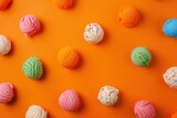 Colorful array of assorted ice cream flavors on a bright orange background
