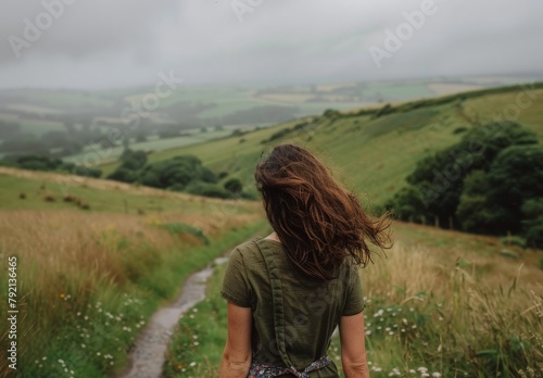 Woman Walking Down Path in Field