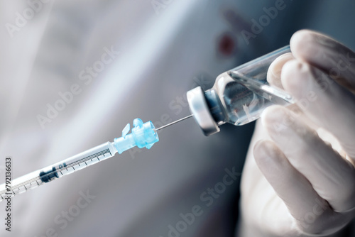 injecting injection vaccine vaccination medicine into a syringe woman nurse photo
