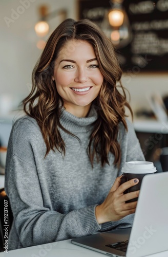 Woman Working on Laptop at Table With Coffee Cup