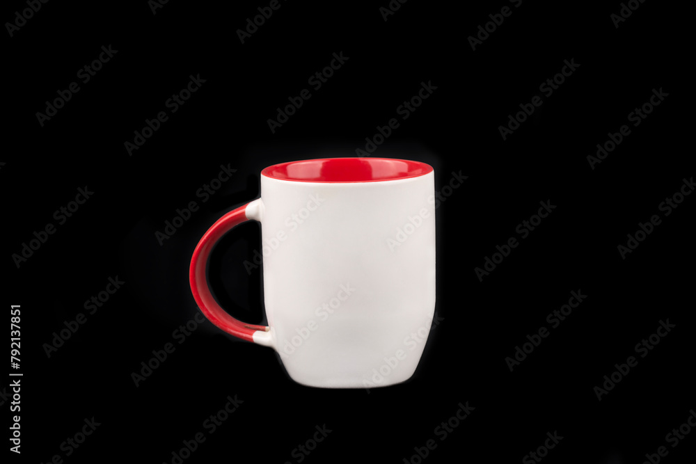 Obraz premium Red and white mug isolated on black background 