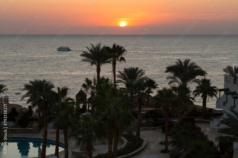 Obraz premium Sunrise on the sea coast. The movement of the sun and clouds across the sky. Park recreation areas of Egypt. Garden and landscape design.