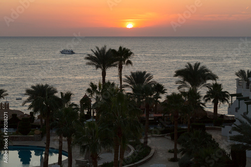 Sunrise on the sea coast. The movement of the sun and clouds across the sky. Park recreation areas of Egypt. Garden and landscape design.