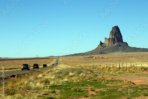 Vehicles pass an impressive rock formation in southern Utah
