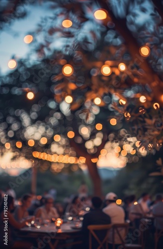 Group of People Sitting at a Table Under a Tree