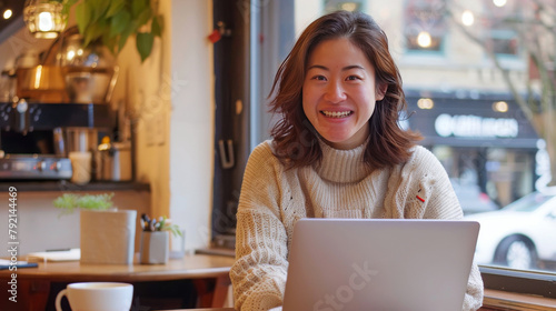 Woman Sitting at Table With Laptop