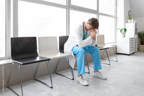 Male medical intern praying...