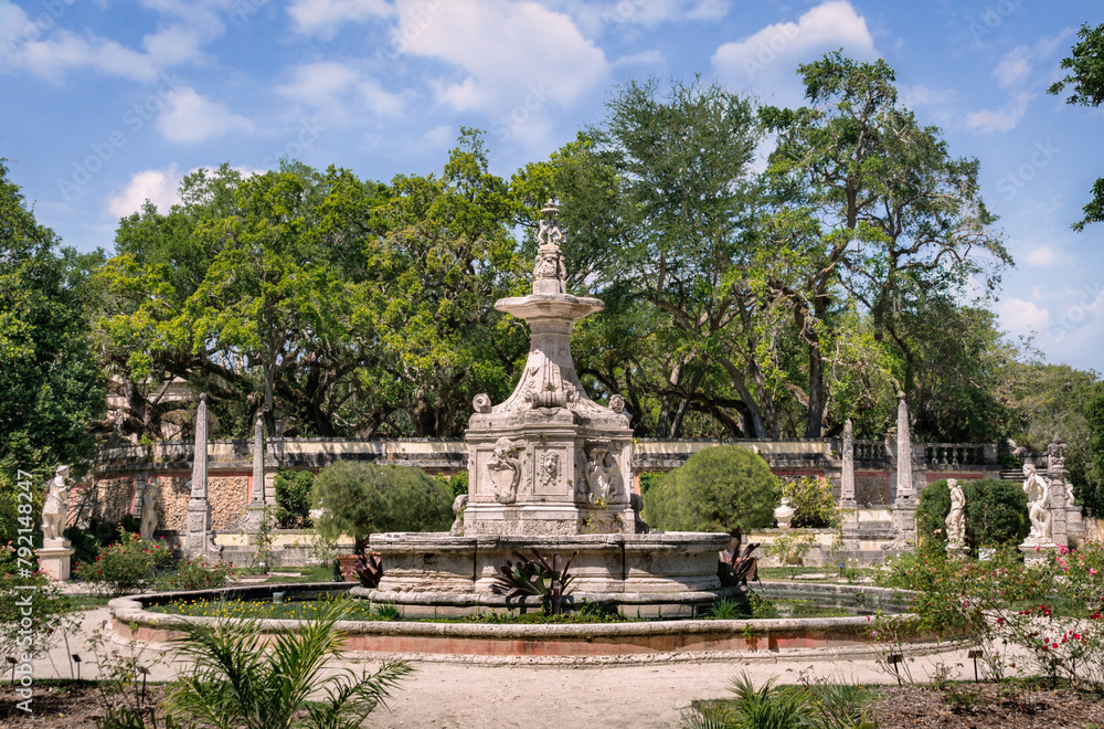 Bright sunny noon view of the exquisite carved fountain in the Fountain Garden of Villa Vizcaya Museum. The Vizcaya Museum and Gardens is the early 20th-century Vizcaya estate also including extensive
