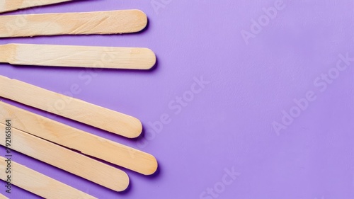 Wooden sticks on purple background photo