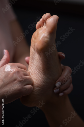 Close-up of a woman's foot massage. Vertical photo.
