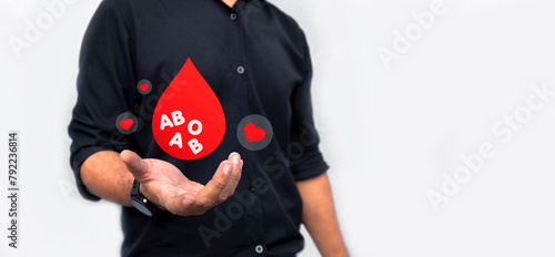 man holding red paper dripping blood. World Blood Donor Day photo