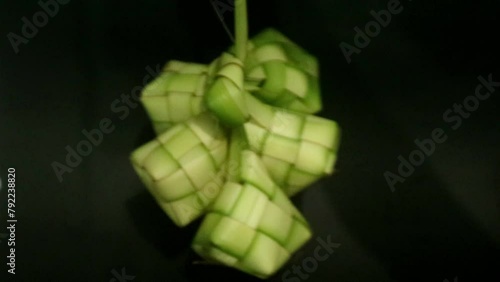 Spinning ketupat and buras, this is a typical traditional Indonesian food which has become part of the people's culture during the Eid season. photo