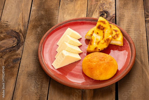 Arepa, almojabana, cheese and hot aguapanela - Typical Colombian breakfast photo