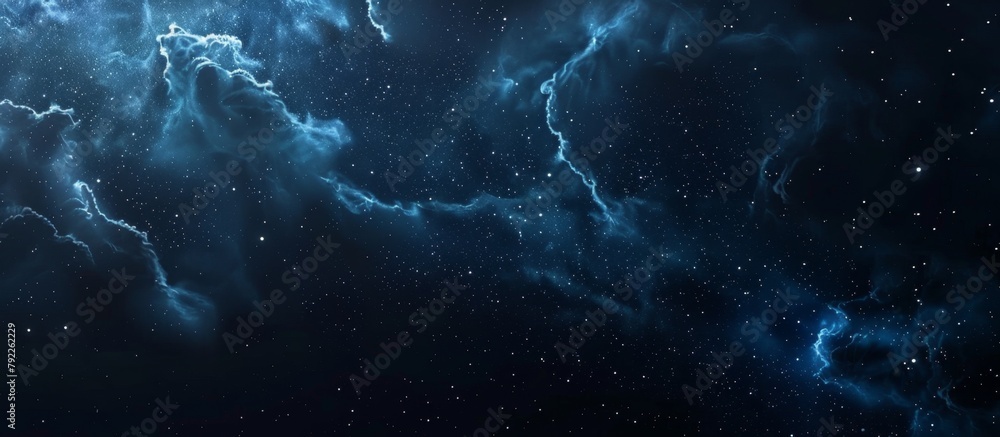 A stunning dark blue galaxy illuminates the sky, filled with twinkling stars and majestic clouds floating in the cosmic expanse A stunning dark blue galaxy illuminates the sky, filled with twinkling stars and majestic clouds floating in the cosmic expanse