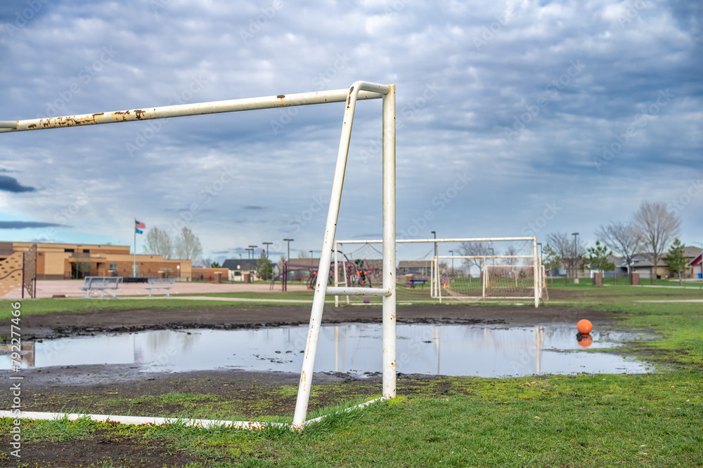 Soccer Goal in Field With Puddle of Water at a school Soccer Goal in Field With Puddle of Water at a school