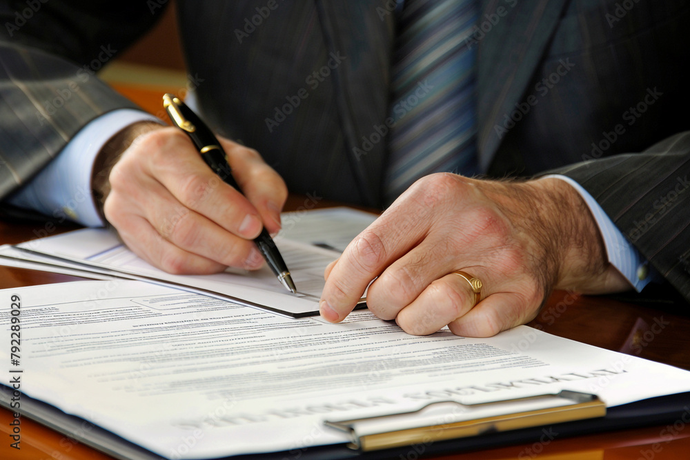 Businessman reviewing a legal document Businessman reviewing a legal document