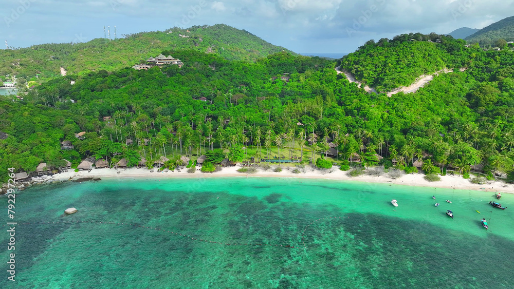 Nature's masterpiece unfolds with sandy shores, verdant trees, and azure waters embracing a luxurious resort-pure coastal elegance. Aerial view. Koh Nangyuan, Southern Thailand. Sea background.
