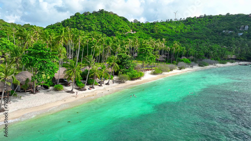 Tranquil green shore  kissed by azure waves. An idyllic resort sanctuary nestled in nature s embrace  offering pure bliss. Tao island  Surat Thani Province  Southern Thailand. Tropical sea background.