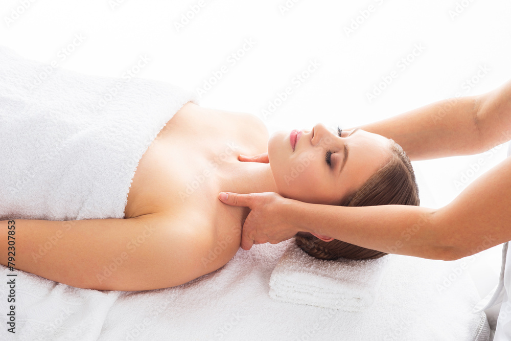 Young woman getting massaging treatment over white. Spa, healthcare and recreation concept. Young woman getting massaging treatment over white. Spa, healthcare and recreation concept.