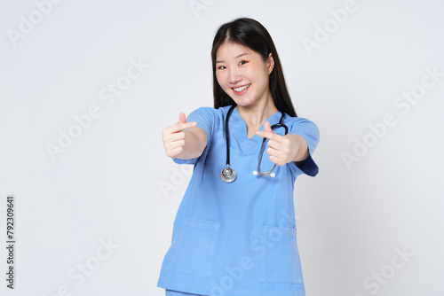 Smiling young woman doctor showing mini heart sign isolated on white background.