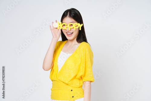 Young asian woman smiling and wearing HAPPY glasses isolate white background.