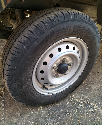 Rear side view front wheel of black car. Selective focus. 