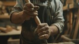 With a focused expression a carpenter holds a chisel in one hand and a mallet in the other delicately shaping a piece of wood. The tools are an extension of their creative vision and .