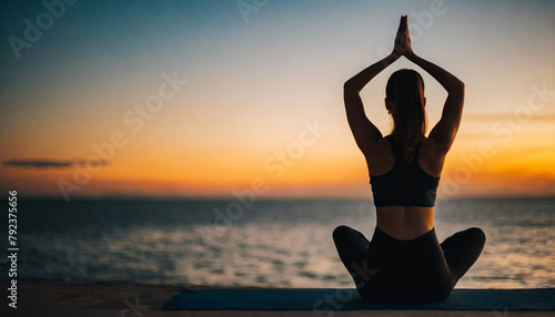 Serene silhouette of a Caucasian woman in yoga attire, practicing yoga at sunset with tranquil mood lighting