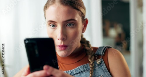 Woman, phone and wow for notification in home with texting, thinking and shock for gossip in living room. Girl, smartphone and surprise for secret, news or story with mobile app for social network photo