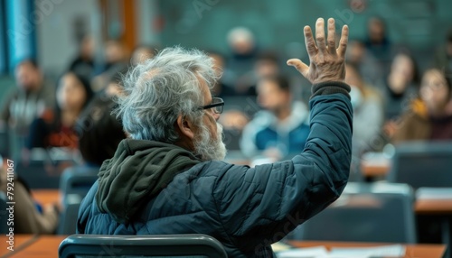 A man is gesturing in a classroom, sharing his answer with the audience