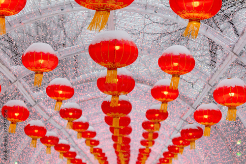 Red lanterns in the snow in the park. Chinese New Year holiday