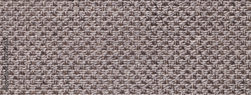 Texture of brown color background from woven textile material with wicker pattern, macro. Vintage fabric cloth,