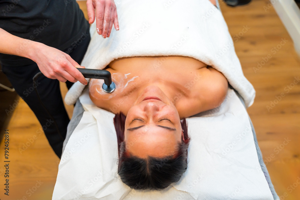 Massage therapist using the INDIBA machine to relieve shoulder pain Massage therapist using the INDIBA machine to relieve shoulder pain