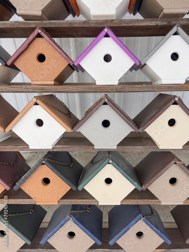row of colorful handmade wooden bird house or huts as a background