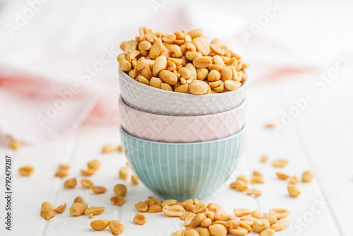 Salted roasted peanuts in bowl on kitchen table