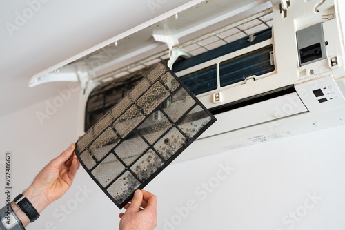 Air conditioner filter dusty. Preparation for maintenance and cleaning