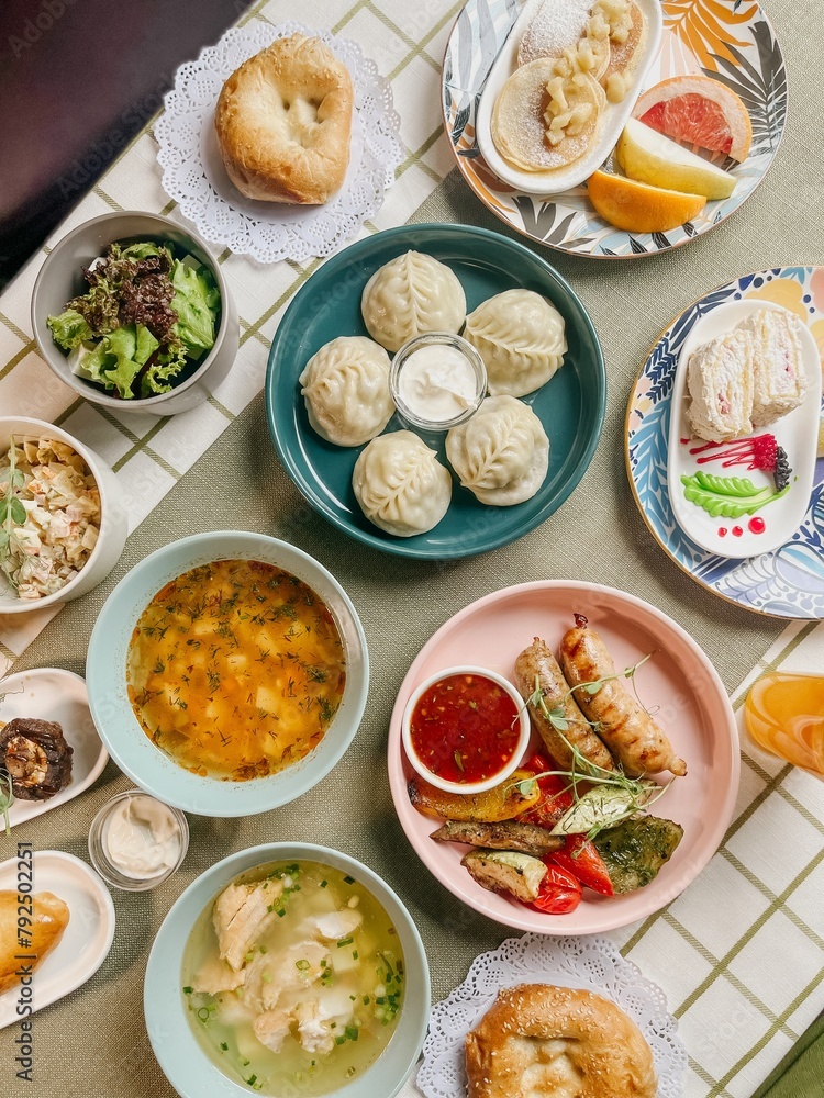 Uzbek Food, Dumplings, Soup, Salad, and Pastries on a Table