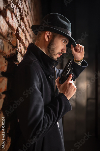 Man a detective with a handgun in hands. Spy surveillance concept.